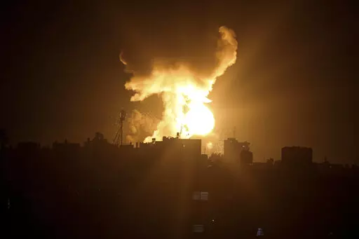 An explosion caused by Israeli airstrikes is seen in the town of Khan Younis, southern Gaza Strip, Sunday Jan, 2, 2022. Israel’s military says it launched strikes against militant targets in the Gaza Strip, a day after rockets were fired from the Hamas-ruled territory. (AP Photo/Yousef Masoud)