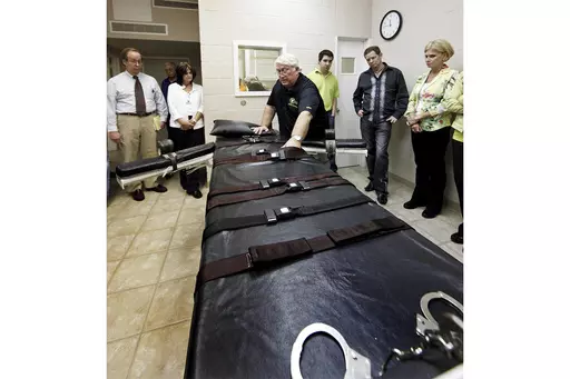 Louisiana State Penitentiary Warden Burl Cain discusses the gurney used for lethal injections, Sept. 18, 2009, at the Louisiana State Penitentiary in Angola, La. After nearly every death row inmate in Louisiana asked for clemency en masse, the state's pardon board turned away all 56 petitions this week. Francis Abbott, executive director of Louisiana’s Board of Pardons and Committee on Parole, confirmed to the Associated Press on Friday, July 28, 2023, that none of the applicants are currently
