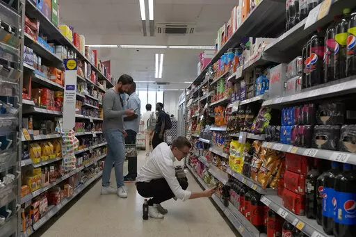 Shoppers buy food in a supermarket in London, Wednesday, Aug. 17, 2022. Britain’s new Prime Minister Liz Truss has pledged to rebuild the economy, but she faces a daunting job. Truss inherits an ailing economy on the brink of a potentially long recession, with record inflation and millions crying out for government help to cope with energy bills. (AP Photo/Frank Augstein, File)