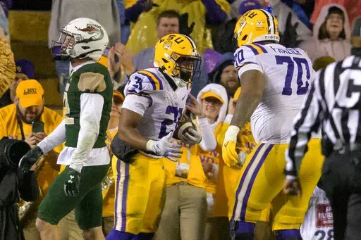 LSU running back Noah Cain (21) celebrates a touchdown against UAB during the first half of an NCAA college football game in Baton Rouge, La., Saturday, Nov. 19, 2022. (AP Photo/Matthew Hinton)
