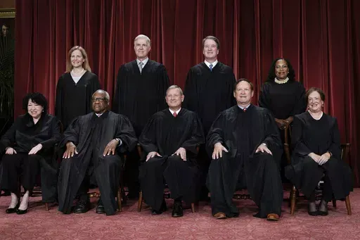 Members of the Supreme Court sit for a new group portrait following the addition of Associate Justice Ketanji Brown Jackson, at the Supreme Court building in Washington, Oct. 7, 2022. Bottom row, from left, Associate Justice Sonia Sotomayor, Associate Justice Clarence Thomas, Chief Justice of the United States John Roberts, Associate Justice Samuel Alito, and Associate Justice Elena Kagan. Top row, from left, Associate Justice Amy Coney Barrett, Associate Justice Neil Gorsuch, Associate Justice 