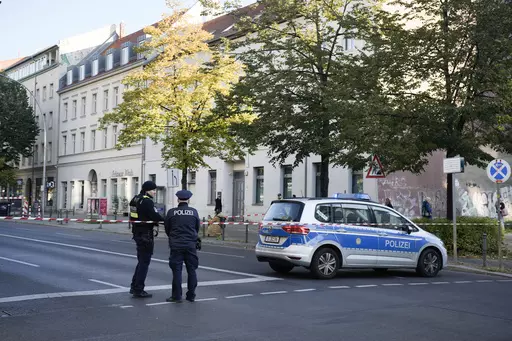 German police officers stand guard in front of the building complex of the Kahal Adass Jisroel community, which houses a synagogue, a kindergarten and a community center, in the center of Berlin, Germany, Wednesday, Oct. 18, 2023. European Union interior ministers met Thursday, Oct. 19, 2023, to discuss how to manage the impact of the war between Israel and Hamas on the bloc, after a firebomb assault on a Berlin synagogue and killings in Belgium and France by suspected Islamist extremists. (AP P