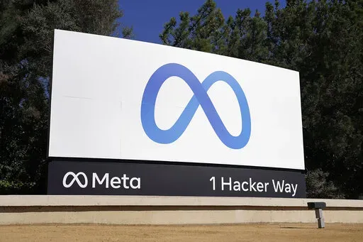 Facebook's Meta logo sign is seen at the company headquarters in Menlo Park, Calif. on Oct. 28, 2021. Federal regulators open their campaign to block Facebook parent Meta’s acquisition of virtual-reality company Within Unlimited and its fitness app Supernatural, with opening arguments beginning Thursday, Dec. 8, 2022, in San Jose, California. (AP Photo/Tony Avelar, File)