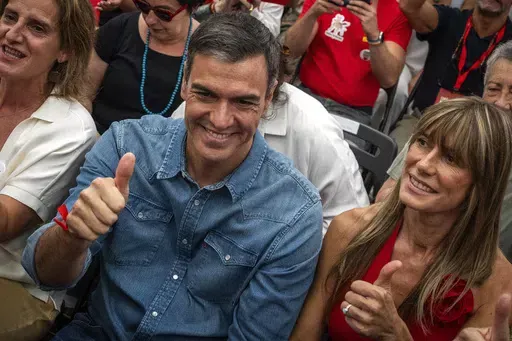 Spain's Prime Minister Pedro Sanchez next to his wife Begona Gomez, gives a thumb up during a campaign closing meeting in Madrid, Spain, Friday, July 21, 2023. Spain is in nail-biting suspense Monday as it waits for Prime Minister Pedro Sanchez to announce whether he will continue in office or not. Sanchez, 52, shocked the country on Thursday, announcing he was taking five days off to think about his future after a court opened preliminary proceedings against his wife on corruption allegations. 