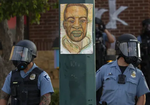 Minneapolis police stand outside the department's 3rd Precinct on May 27, 2020, in Minneapolis. Almost two years after George Floyd died at the hands of four Minneapolis police officers, Minnesota's Department of Human Rights was set Wednesday, April 27, 2022, to announce findings from its investigation into whether the city police department had a pattern or practice of racial discrimination in policing. (Carlos Gonzalez/Star Tribune via AP)