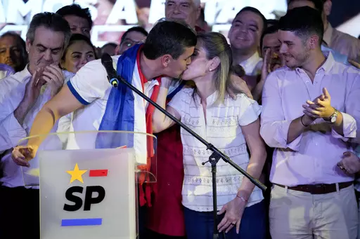 Santiago Peña, presidential candidate of the Colorado ruling party, kisses his wife Leticia Ocampos after the voting closed during general elections in Asuncion, Paraguay, Sunday, April 30, 2023. (AP Photo/Jorge Saenz)