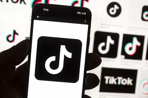 The TikTok logo is seen on a cellphone on Oct. 14, 2022, in Boston. TikTok says every account held by a user under the age of 18 will automatically be set to a 60-minute daily screen time limit in the coming weeks amid growing concerns about the app's security. (AP Photo/Michael Dwyer, File)