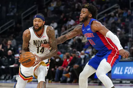 New Orleans Pelicans forward Brandon Ingram (14) drives on Detroit Pistons forward Saddiq Bey (41) in the second half of an NBA basketball game in Detroit, Tuesday, Feb. 1, 2022. (AP Photo/Paul Sancya)