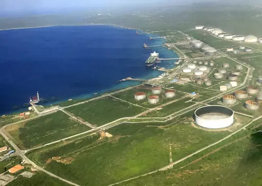 The Bullenbaai oil terminal sits along the coast of the Dutch Caribbean island of Curacao near Willemstad, Dec. 24, 2016. The terminal is at the center of an effort by Venezuela to get around U.S. sanctions, the Associated Press has learned. (AP Photo/Dick Drayer)
