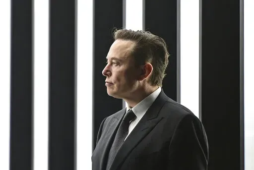Elon Musk, Tesla CEO, attends the opening of the Tesla factory Berlin Brandenburg in Gruenheide, Germany, March 22, 2022. Musk, the world's richest man and the owner of SpaceX and Tesla, says he is a free speech absolutist who doesn't support the kind of content moderation that saw people like ex-President Donald Trump get banned for inciting violence (Patrick Pleul/Pool via AP, File)