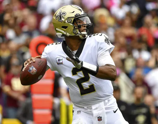 New Orleans Saints quarterback Jameis Winston prepares to pass the ball during the first half of an NFL football game against the Washington Football Team, Oct. 10, 2021, in Landover, Md. A person familiar with the situation says free agent Winston has agreed to return to the Saints. The person spoke to The Associated Press on condition of anonymity on Monday, March 21, 2022, because the agreement has not been announced. (AP Photo/Terrance Williams, File)