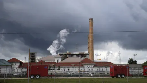 Rain clouds gather over the New Orleans Sewerage & Water Board facility, Aug. 10, 2017, in New Orleans. (AP Photo/Gerald Herbert, File)