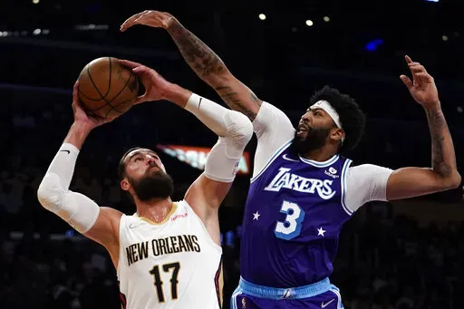 Los Angeles Lakers forward Anthony Davis (3) defends against New Orleans Pelicans center Jonas Valanciunas (17) during the first half of an NBA basketball game in Los Angeles, Friday, April 1, 2022. (AP Photo/Ashley Landis)