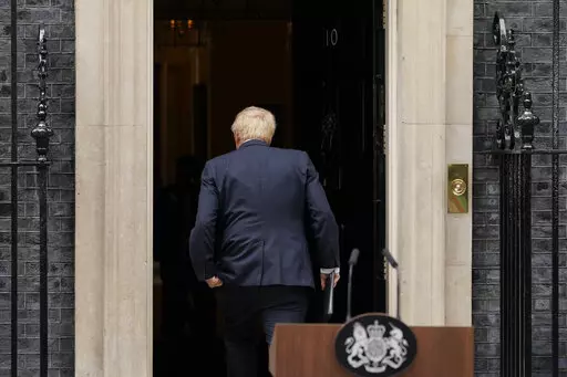 Prime Minister Boris Johnson enters 10 Downing Street, after reading a statement in London, Thursday, July 7, 2022. Boris Johnson has stepped down as Conservative Party leader, but the scandal-tarnished politician remains Britain’s prime minister — for now. Johnson’s resignation sparks a party contest to replace him as leader. All Conservative lawmakers are eligible to run, and party officials could open the nominations within hours. (AP Photo/Alberto Pezzali)