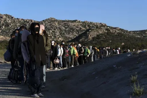 Chinese migrants wait to be processed after crossing the border with Mexico on May 8, 2024, near Jacumba Hot Springs, Calif. Arrests for illegally crossing the border from Mexico plunged 29% in June to the lowest month of Joe Biden's presidency, according to figures released Monday, July 15, 2024, that provide another window on the impact of a new rule to temporarily suspend asylum. (AP Photo/Ryan Sun,File)