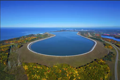 This undated photo provided by Consumers Energy shows an aerial view of the Ludington Pumped Storage Plant near Ludington, Mich. The plant generates electricity by pumping water from Lake Michigan to a reservoir on top of a bluff, then releasing it through giant turbines as needed. Advocates of pumped storage call such facilities the "world's largest batteries." (AP Photo/Consumers Energy)