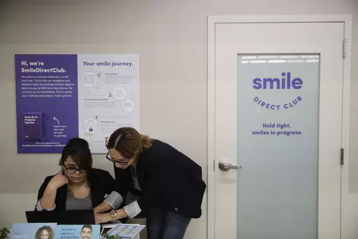 Dental assistants go over appointments at SmileDirectClub's SmileShop located inside a CVS store April 24, 2019, in Downey, Calif. SmileDirectClub is shutting down, just months after the struggling teeth-straightening company filed for bankruptcy, leaving existing customers in limbo. On Friday, Dec. 8, 2023, the company said it was unable to find a partner willing to bring in enough capital to keep the company afloat, despite a months-long search. (AP Photo/Jae C. Hong)