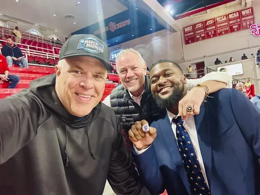 This photo provided by Chuck Everson shows 1985 national champion Villanova Wildcats Chuck Everson, left, and Brian Harrington, middle, return a lost 2016 national championship ring to Kris Jenkins on Nov. 9, 2024 at Carnesecca Arena on the campus of St Johns in New York. (Chuck Everson via AP)