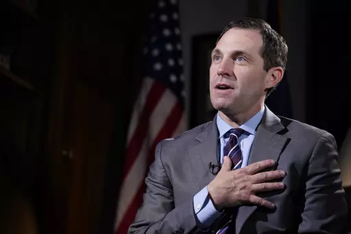 Rep. Jason Crow, D-Colo., talks during an interview with The Associated Press in his office on Capitol Hill in Washington, Dec. 15, 2021. Two decades ago, Crow was a 24-year-old platoon leader in the American invasion of Iraq. Platoon members carried gas masks and gear to wear over their uniforms to protect them from the chemical weapons the U.S. believed – wrongly – that Iraqi forces might use against them. Today, Crow sits on committees that oversee the U.S. military and intelligence agenc