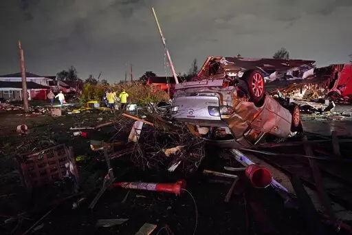 A car is flipped over after a tornado tore through the area in Arabi, La., Tuesday, March 22, 2022, in a part of the city that had been heavily damaged by Hurricane Katrina 17 years earlier. A United Nations report released on Monday, April 25, 2022, says disasters are on the rise are just going to get worse. A new UN report says the number of disasters, from climate change to COVID-19, are going to jump to about 560 a year by 2030. (AP Photo/Gerald Herbert, File)
