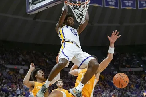 LSU forward Tari Eason (13) dunks against Tennessee forward Olivier Nkamhoua, left, and guard Kennedy Chandler (1) during the second half of an NCAA college basketball game in Baton Rouge, La., Saturday, Jan. 8, 2022. (AP Photo/Matthew Hinton)