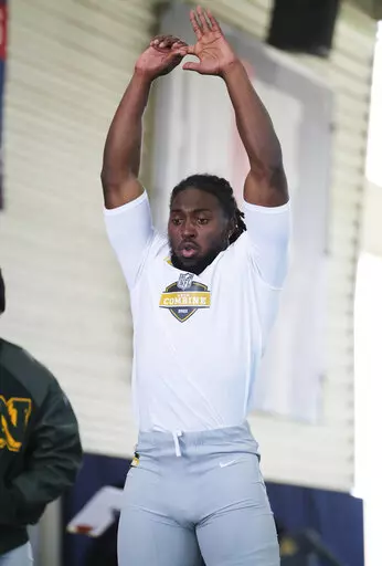 Alabama State running back Ezra Gray stretches out before doing a broad jump at the NFL HBCU Combine at the University of South Alabama in Mobile, Ala. on Saturday, Jan. 29, 2022. Nearly a year after no HBCU players were selected in the NFL Draft, Gray and other products of of historically black colleges and universities have somethig to prove. (Dan Anderson/AP Images for NFL)