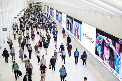 Commuters walk through a corridor in the World Trade Center Transportation Hub in New York on June 21, 2019. The pandemic’s Great Resignation has produced a Great Reinvention as more people of all ages have given up on jobs and find themselves pondering the work-life balance that lends meaning to their lives. (AP Photo/Mark Lennihan, File)