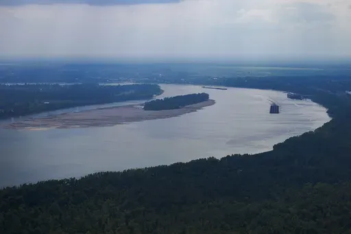 In this aerial photo a tugboat pushing barges navigates around sandbars amid low water levels on the Mississippi River in Livingston Parish, La., Sept. 14, 2023. (AP Photo/Gerald Herbert, File)
