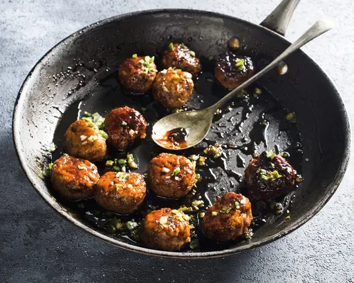 This image released by Milk Street shows a recipe for Japanese chicken meatballs. (Milk Street via AP)