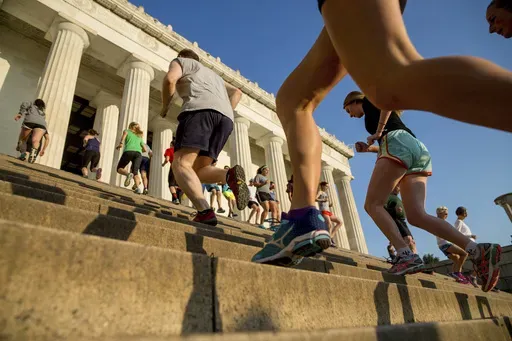 Members of the November Project fitness group run up and down the stairs of the Lincoln Memorial in Washington on May 25, 2016. (AP Photo/Andrew Harnik, File)
