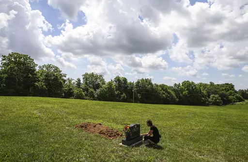 Kelly Vervillas, of Shepherdsville, Ky., visits the gravesite of the unknown boy who was found in a suitcase in April 2022 in Washington County, on June 1, 2022, in Salem, Ind. A Louisiana woman charged in the death of a boy whose body was found last year inside a suitcase in rural southern Indiana is seeking a change of venue Monday, May 15, 2023, arguing that public outrage over the child's death would prevent her from getting a fair trial. (Matt Stone/Courier Journal via AP, File)