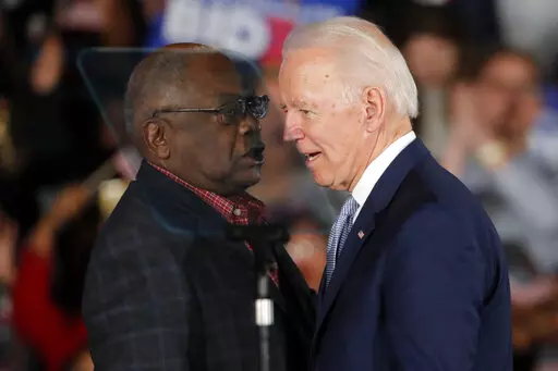 Then-Democratic presidential candidate Joe Biden talks to Rep. James Clyburn, D-S.C., at a primary night election rally in Columbia, S.C., Feb. 29, 2020 after winning the South Carolina primary. President Biden has frequently referenced the critical role South Carolina played in his nomination. He points to his decades-long relationship with the state whose Black voters handed him a major win at a desperate time for his Democratic campaign. But, in recent interviews with The Associated Press, so