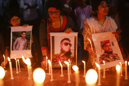 People light candles to pay tribute to victims of a massive fire at the BM Inland Container Depot, at Chittagong as they gather at Shahid Minar in Dhaka, Bangladesh, Monday, June 6, 2022. Authorities in Bangladesh were still struggling Monday to determine the cause of the devastating fire that killed at least 49 people, including nine firefighters, and injured more than 100 others. (AP Photo/Mahmud Hossain Opu)