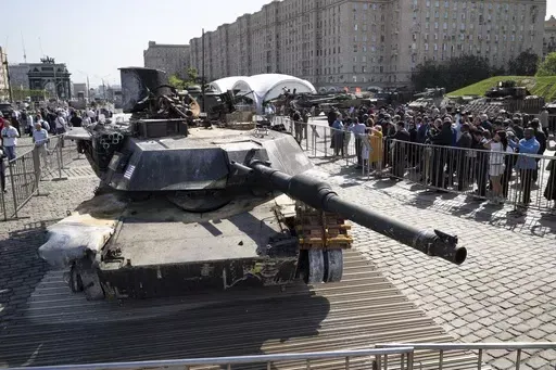 Representatives of the diplomatic corps look at U.S.-made M1 Abrams tank, and other U.S. military vehicles, hit and captured by Russian troops during the fighting in Ukraine as they visit an exhibition of Western military equipment seized from Ukrainian forces, in Moscow, on Friday, May 31, 2024. The exhibit, organized by the Russian Defense Ministry, features more than 30 pieces of Western-made heavy equipment, including a U.S.-made M1 Abrams tank and a Bradley armored fighting vehicle. (AP Pho