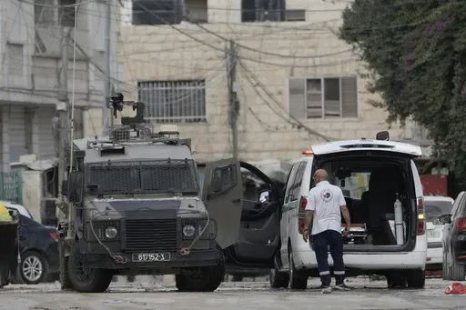 Members of the Israeli forces inside an armoured vehicle check an ambulance during a military operation in the West Bank city of Jenin, Wednesday, Aug. 28, 2024. (AP Photo/Majdi Mohammed)