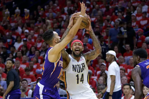 New Orleans Pelicans forward Brandon Ingram (14) shoots against Phoenix Suns guard Landry Shamet in the first half of Game 4 of an NBA basketball first-round playoff series in New Orleans, Sunday, April 24, 2022. (AP Photo/Matthew Hinton)