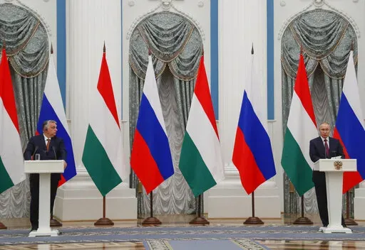 Hungary's Prime Minister Viktor Orban, left, and Russian President Vladimir Putin attend a joint news conference following their talks in the Kremlin in Moscow, Russia, Feb. 1, 2022. Orban, has nurtured close political and economic ties with Russia for more than a decade. But following Russia's large-scale invasion of Ukraine, Hungary's neighbor, Orban is facing growing pressure to change course. (Yuri Kochetkov/Pool Photo via AP)