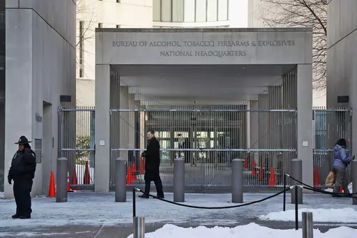 A security official walks in front of the entrance to the national headquarters of the Bureau of Alcohol, Tobacco, Firearms and Explosives on Jan. 23, 2014, in Washington. New data from the bureau shows that 68,000 illegally trafficked firearms in the U.S. came through unlicensed dealers who aren't required to perform background checks over a five year report that was released Thursday, April 4, 2024. (AP Photo/Charles Dharapak, File)