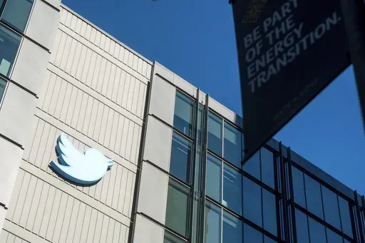 A Twitter logo hangs outside the company's San Francisco offices on Nov. 1, 2022. A top European Union official warned Elon Musk on Wednesday Nov. 30, 2022 that Twitter needs to beef up measures to protect users from hate speech, misinformation and other harmful content to avoid violating new rules that threaten tech giants with big fines or even a ban in the 27-nation bloc. (AP Photo/Noah Berger, File)