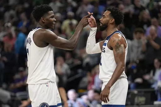 Minnesota Timberwolves guard Anthony Edwards, left, celebrates with guard Mike Conley after making a free throw during the second half of an NBA basketball game against the New Orleans Pelicans, Sunday, April 9, 2023, in Minneapolis. (AP Photo/Abbie Parr)