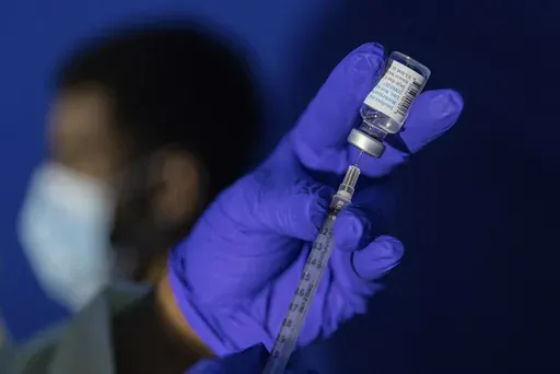 A family nurse practitioner prepares a syringe with the Mpox vaccine for inoculating a patient at a vaccination site in the Brooklyn borough of New York, on Tuesday, Aug. 30, 2022. Scientists say a new form of mpox detected in a mining town in Congo might more easily spread among people. Already, Congo is seeing its biggest mpox outbreak with more than 19,000 suspected infections and 900 deaths. . (AP Photo/Jeenah Moon, File)