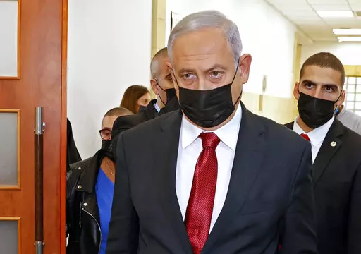 Former Israeli Prime Minister Benjamin Netanyahu leaves a Jerusalem courthouse, Nov. 16, 2021. Israeli media reports say police have used sophisticated spyware against a key witness in the corruption trial of former Israeli Prime Minister Benjamin Netanyahu. The revelations have jolted the trial and shine a light on a contentious Israeli-developed surveillance tool. (Jack Guez/Pool Photo via AP, File)