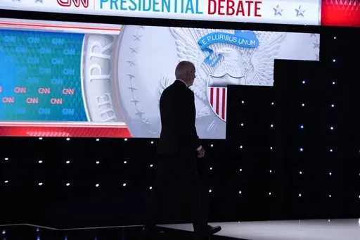 President Joe Biden walks from the stage during a break in a presidential debate with Republican presidential candidate former President Donald Trump Thursday, June 27, 2024, in Atlanta. (AP Photo/Gerald Herbert)