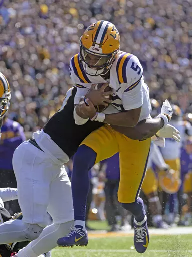 LSU quarterback Jayden Daniels (5) is hit by Missouri defensive back Daylan Carnell in the second half of an NCAA college football game Saturday, Oct. 7, 2023, in Columbia, Mo. (Hilary Scheinuk/The Advocate via AP)