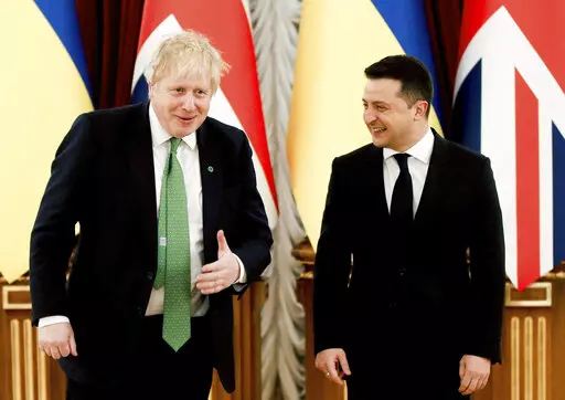 Britain's Prime Minister Boris Johnson, left, reacts with Ukrainian President Volodymyr Zelenskyy, prior to their talks amid rising tension between Ukraine and Russia, at the presidential palace, in Kyiv, Ukraine, Tuesday, Feb. 1, 2022.  (Peter Nicholls/Pool Photo via AP)