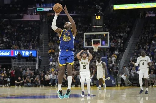 Golden State Warriors guard Buddy Hield (7) shoots a three-point basket at the first half buzzer during an NBA basketball game against the New Orleans Pelicans in San Francisco, Wednesday, Oct. 30, 2024. (AP Photo/Jeff Chiu)