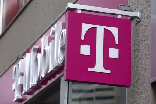 The T-Mobile logo is seen on a storefront, on Oct. 14, 2022, in Boston. Customers of the wireless provider reported widespread service outages in the U.S. late Monday, Feb. 13, 2023, according to websites tracking service interruptions. (AP Photo/Michael Dwyer, File)